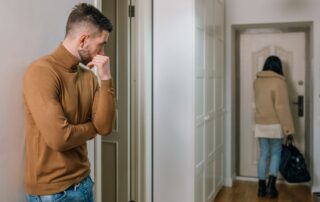 Man Looking at a Woman Walking Out of the Apartment