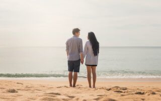 couple holding hands at the beach