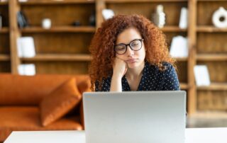 a woman sitting in front of her laptop